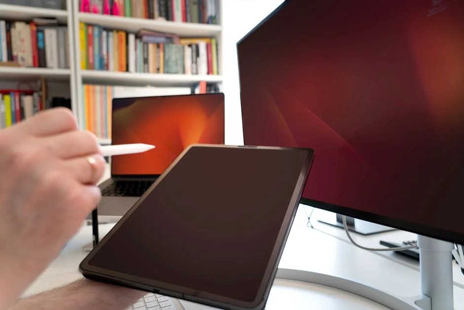 High-tech trading setup with charts on tablet and computer screens, representing data analysis and financial trends.